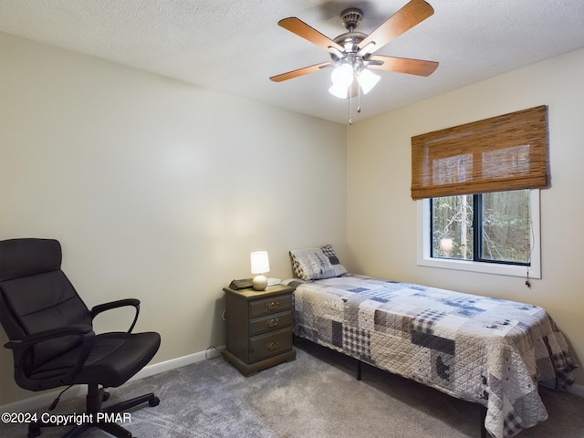 bedroom featuring a ceiling fan, carpet flooring, a textured ceiling, and baseboards