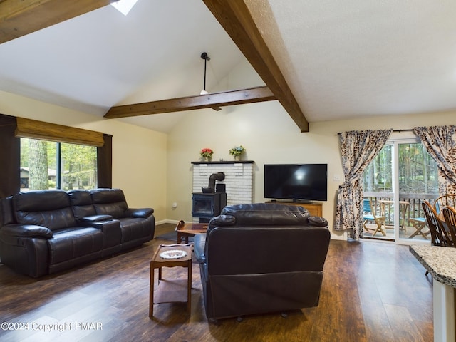 living area with vaulted ceiling with beams, plenty of natural light, dark wood finished floors, and a wood stove