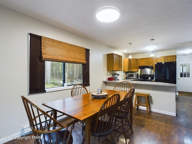 dining room with baseboards and dark wood finished floors