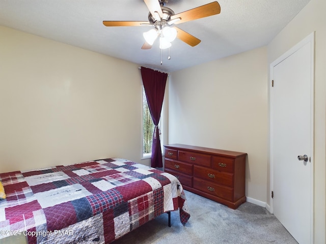 bedroom featuring a ceiling fan, light colored carpet, and baseboards