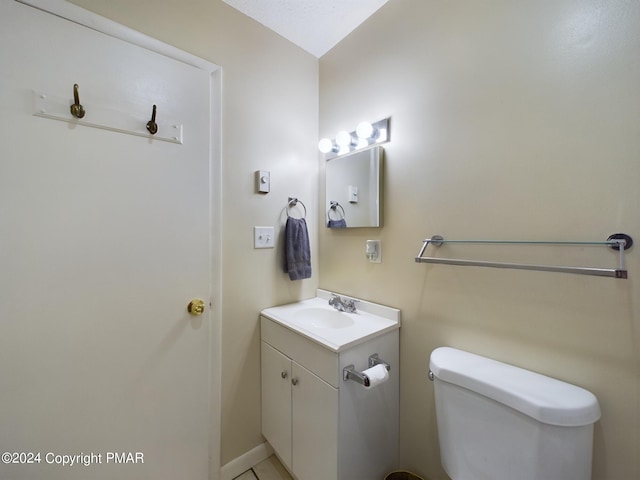 half bathroom featuring vanity and toilet