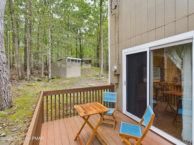 wooden deck with a shed and an outdoor structure