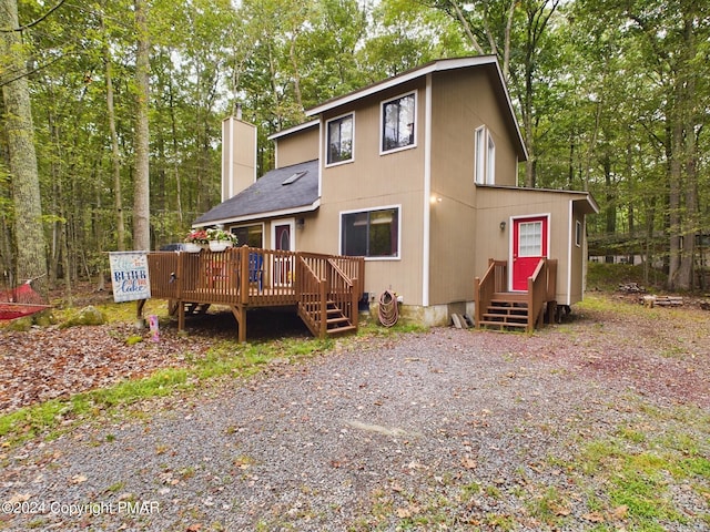 view of front of home featuring a deck and a chimney