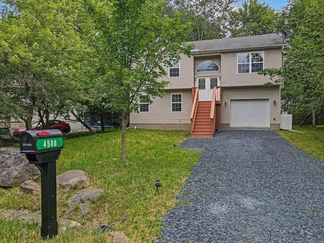 4580 Briarcliff Ter, Tobyhanna, PA 18466 - bi-level home with a garage, a front lawn, and gravel driveway