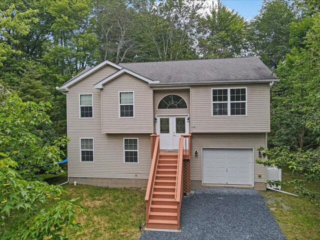4580 Briarcliff Ter, Tobyhanna, PA 18466 - raised ranch with an attached garage, driveway, and view of scattered trees