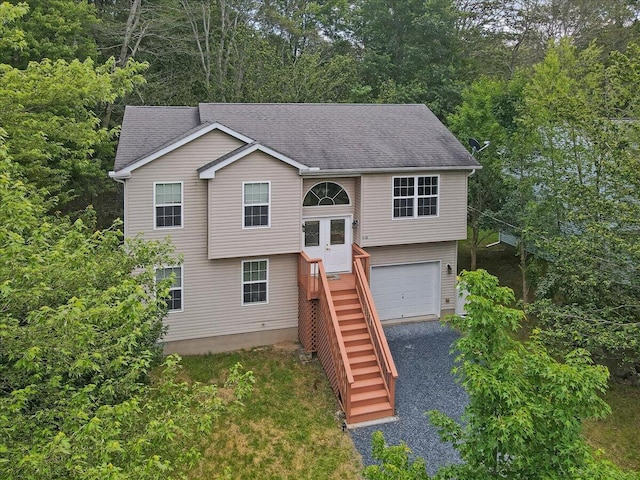 4580 Briarcliff Ter, Tobyhanna, PA 18466 - bi-level home with an attached garage, driveway, roof with shingles, and stairs