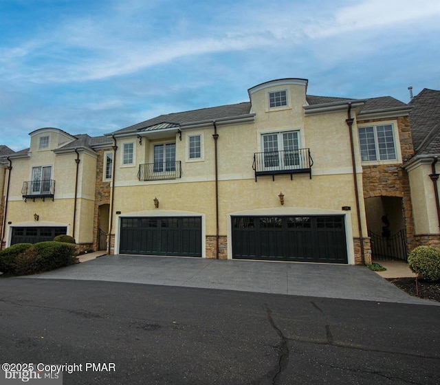 townhome / multi-family property with a garage and central air condition unit