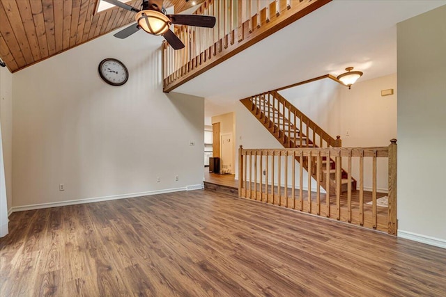 1220 Delaware Ave, East Stroudsburg, PA 18301 - unfurnished living room with a ceiling fan, high vaulted ceiling, wood finished floors, and stairway