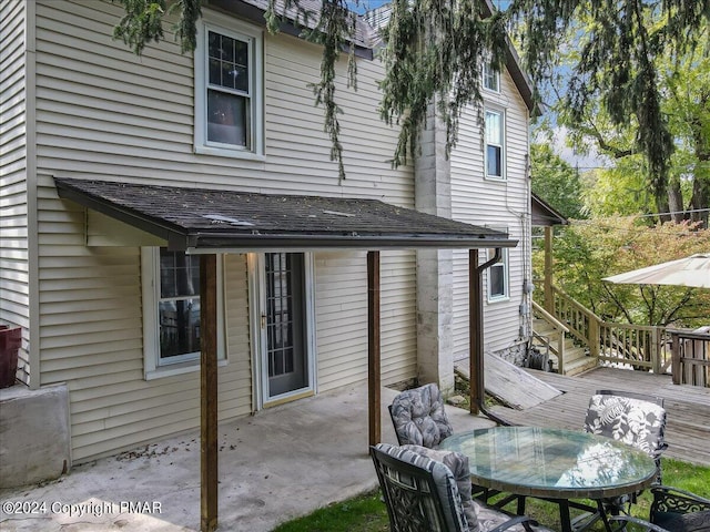 7714 Cherry Valley Rd, Delaware Water Gap, PA 18327 - back of house featuring outdoor dining space, a patio area, roof with shingles, and a deck
