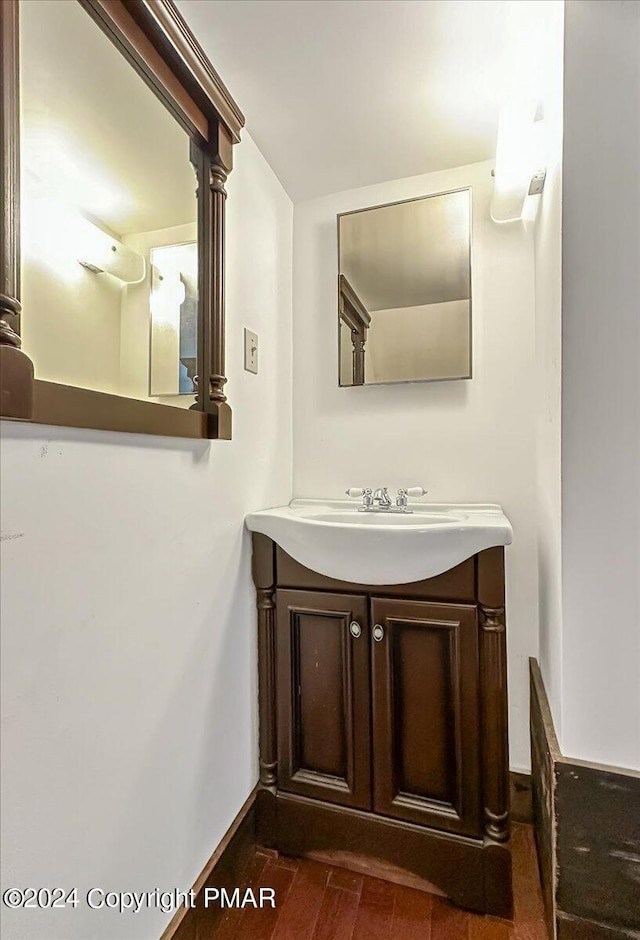 7714 Cherry Valley Rd, Delaware Water Gap, PA 18327 - bathroom with wood finished floors, vanity, and baseboards