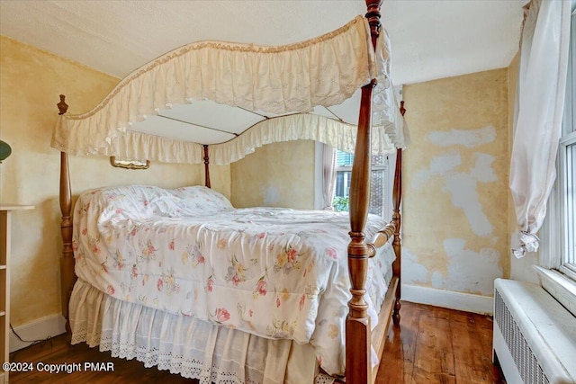7714 Cherry Valley Rd, Delaware Water Gap, PA 18327 - bedroom featuring baseboards, multiple windows, wood finished floors, and radiator