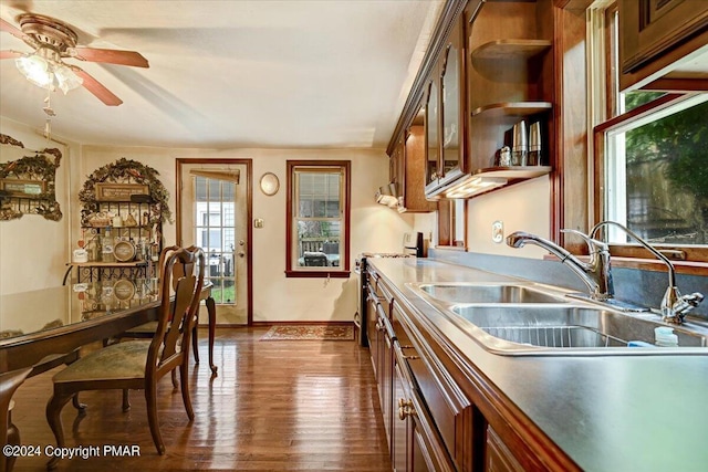 7714 Cherry Valley Rd, Delaware Water Gap, PA 18327 - kitchen with dark wood-style flooring, stove, glass insert cabinets, a sink, and baseboards
