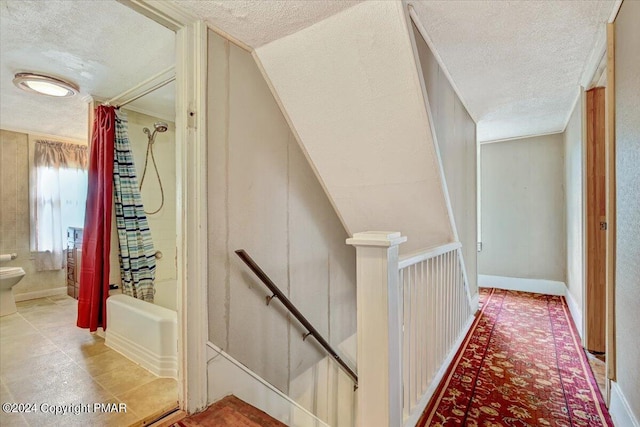 7714 Cherry Valley Rd, Delaware Water Gap, PA 18327 - hallway with a textured ceiling, an upstairs landing, and baseboards