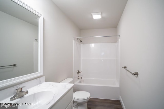 bathroom with tub / shower combination, vanity, toilet, and wood finished floors