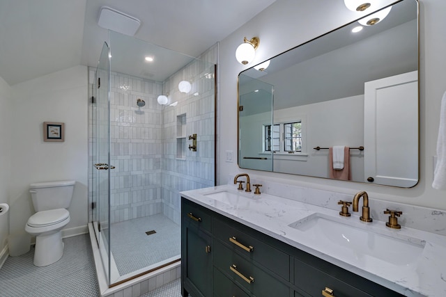 bathroom featuring a sink, toilet, double vanity, and a shower stall