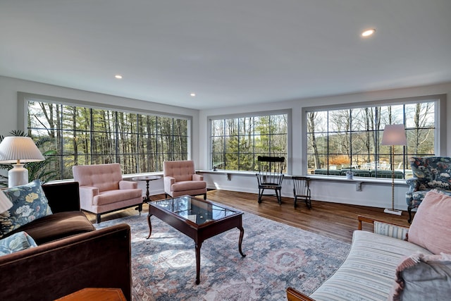 living area featuring recessed lighting, baseboards, and wood finished floors