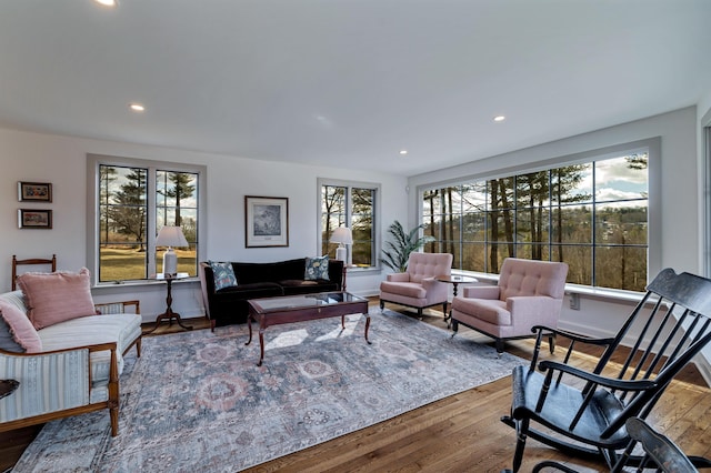 living room featuring recessed lighting, baseboards, and hardwood / wood-style floors