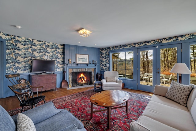 living room featuring recessed lighting, a brick fireplace, wood finished floors, and wallpapered walls