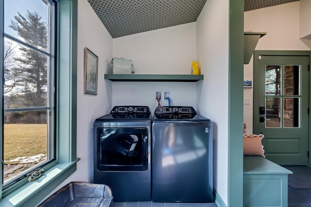 clothes washing area featuring separate washer and dryer and a healthy amount of sunlight