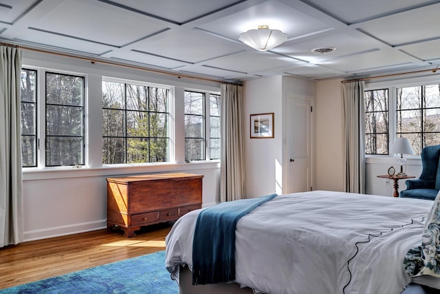 bedroom featuring visible vents, multiple windows, coffered ceiling, and wood finished floors