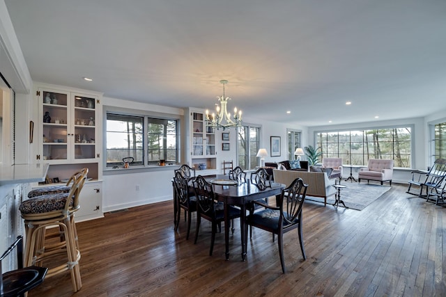 dining room with recessed lighting, a notable chandelier, baseboards, and dark wood-type flooring