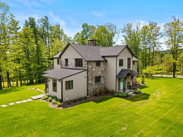 5106 Beattys Cir, Buck Hill Falls, PA 18323 - view of front of house featuring stone siding, a chimney, a front lawn, and roof with shingles