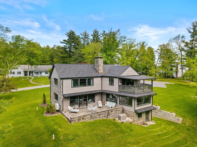 5106 Beattys Cir, Buck Hill Falls, PA 18323 - rear view of property with a balcony, a patio, a chimney, a yard, and stone siding