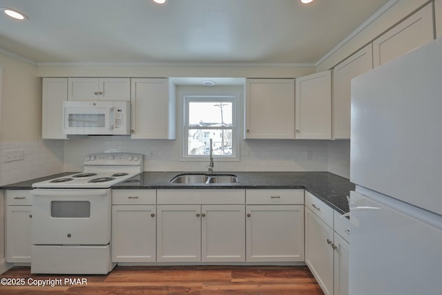 kitchen with recessed lighting, backsplash, white cabinetry, a sink, and white appliances