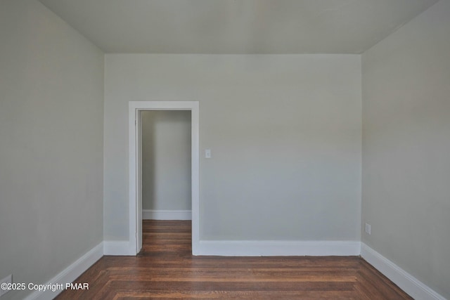 unfurnished room with baseboards and parquet flooring