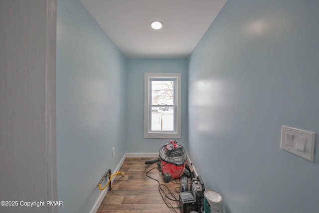 interior space featuring baseboards and wood finished floors