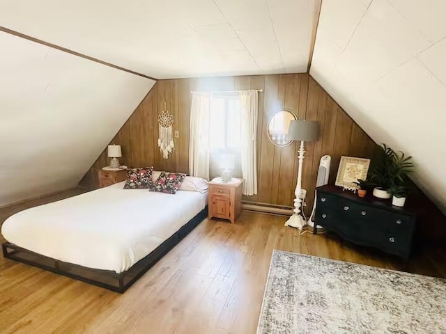 174 Bushkill Dr, Pocono Lake, PA 18347 - bedroom with lofted ceiling, wood finished floors, baseboard heating, and wooden walls