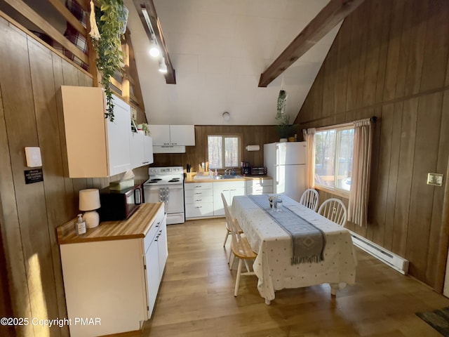 174 Bushkill Dr, Pocono Lake, PA 18347 - kitchen featuring white appliances, wooden walls, light wood-type flooring, white cabinets, and under cabinet range hood