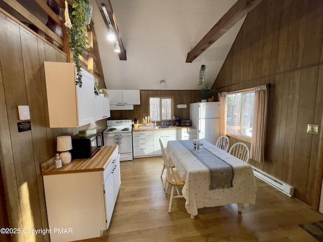 kitchen featuring a wealth of natural light, a baseboard radiator, white appliances, and beamed ceiling