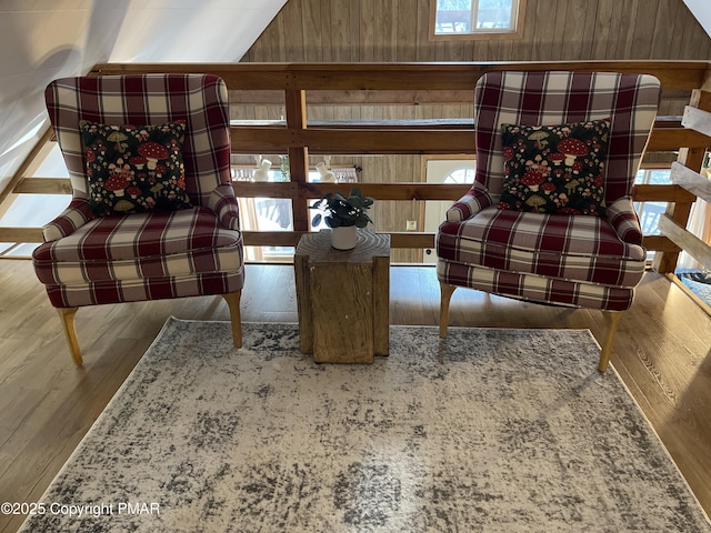 living area featuring wooden walls and wood finished floors