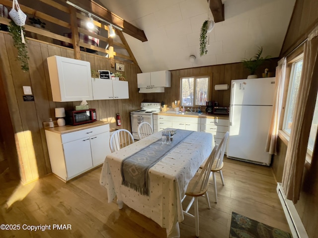 kitchen featuring light wood-style floors, white appliances, vaulted ceiling with beams, and baseboard heating