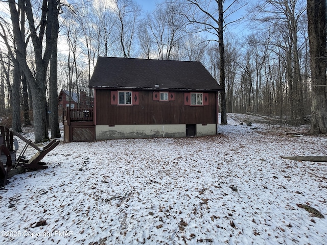 view of front of home featuring roof with shingles and crawl space