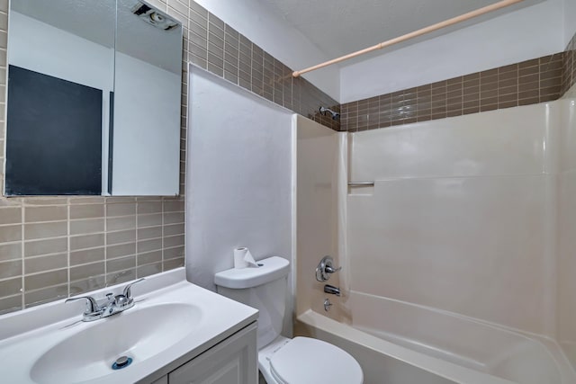 bathroom with decorative backsplash, vanity, toilet, and shower / bath combination