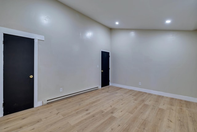 spare room featuring light wood-style flooring, recessed lighting, baseboards, and baseboard heating