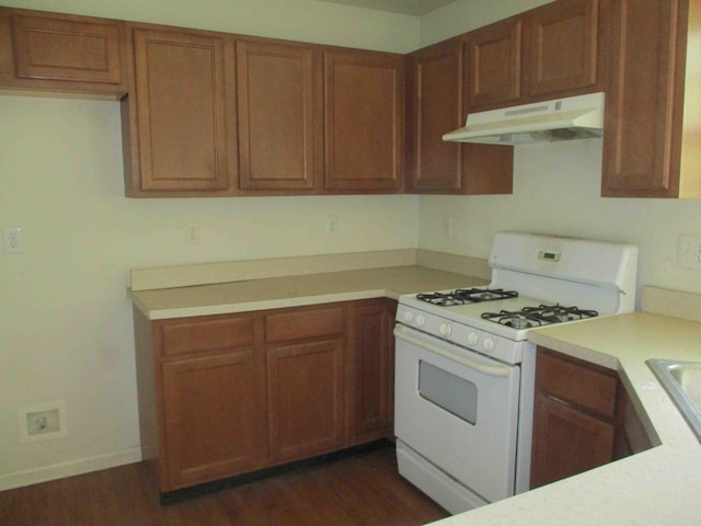2113 Dorset Ct, Bushkill, PA 18324 - kitchen featuring under cabinet range hood, white range with gas stovetop, light countertops, and brown cabinets