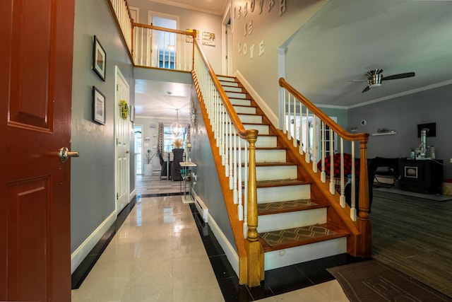 9 Hickory Dr, East Stroudsburg, PA 18301 - staircase featuring crown molding, ceiling fan, tile patterned flooring, and a wood stove