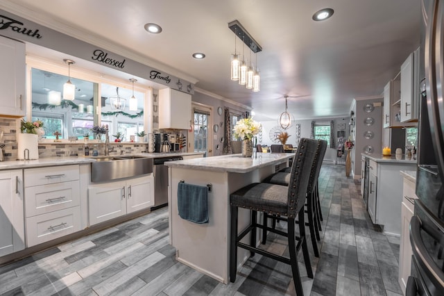 9 Hickory Dr, East Stroudsburg, PA 18301 - kitchen featuring dishwasher, a chandelier, ornamental molding, a kitchen island, and decorative backsplash