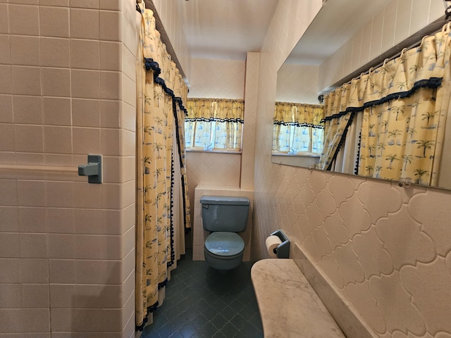 130 Michigana Dr, Pocono Lake, PA 18347 - full bathroom with tile patterned flooring, a shower with shower curtain, toilet, and tile walls