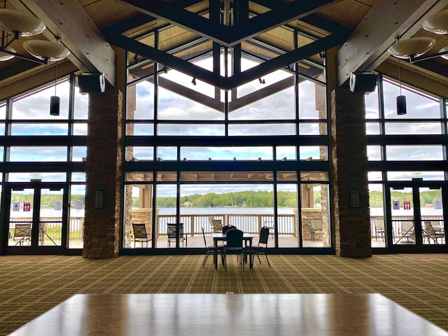 130 Michigana Dr, Pocono Lake, PA 18347 - carpeted living room with a water view, a wealth of natural light, and a towering ceiling