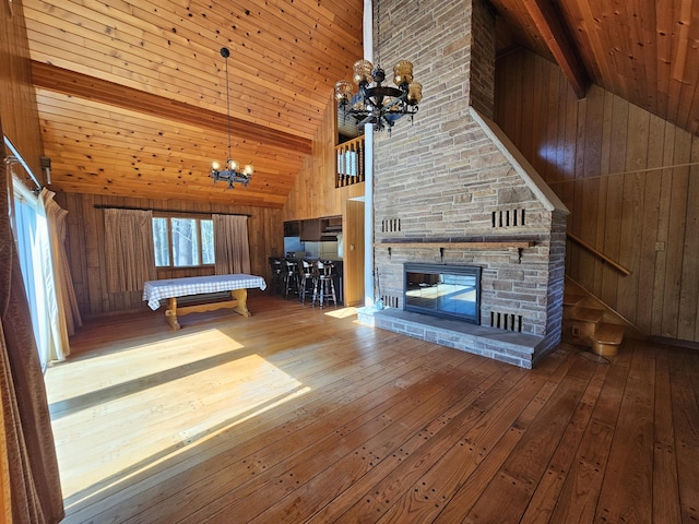 130 Michigana Dr, Pocono Lake, PA 18347 - unfurnished living room with high vaulted ceiling, wooden ceiling, wood-type flooring, wooden walls, and an inviting chandelier