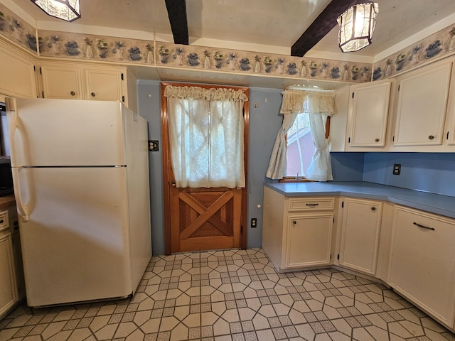 130 Michigana Dr, Pocono Lake, PA 18347 - kitchen featuring freestanding refrigerator, beamed ceiling, and white cabinets