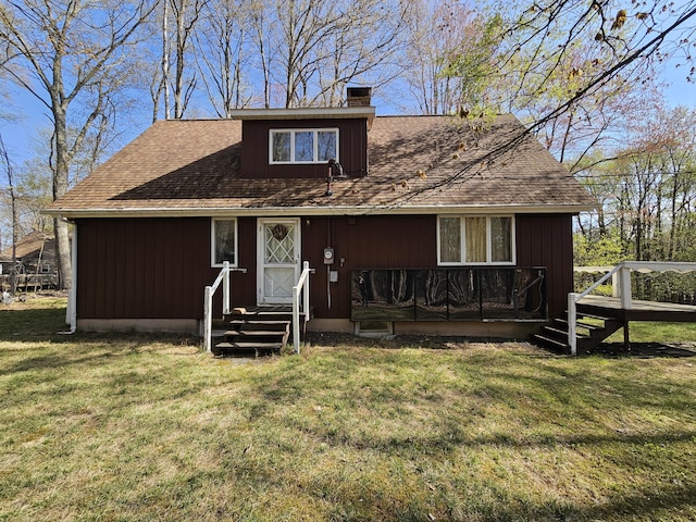130 Michigana Dr, Pocono Lake, PA 18347 - view of front of house featuring a front yard, a chimney, entry steps, and a wooden deck