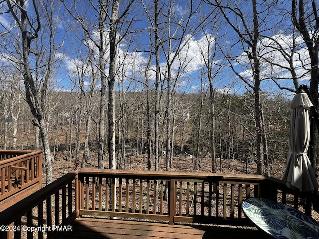 wooden deck with a view of trees