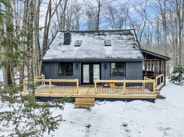 view of front of home with a deck and a chimney