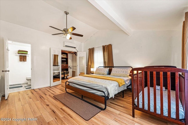 bedroom with lofted ceiling with beams, light wood-type flooring, a wall mounted air conditioner, and a ceiling fan