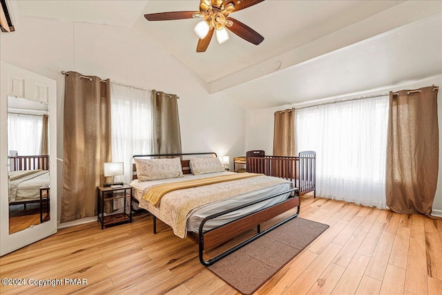 bedroom with light wood finished floors, ceiling fan, and vaulted ceiling